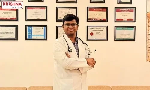 Dr. Nikhil Govindwar standing at his clinic with hands folded with certificates on wall in background.