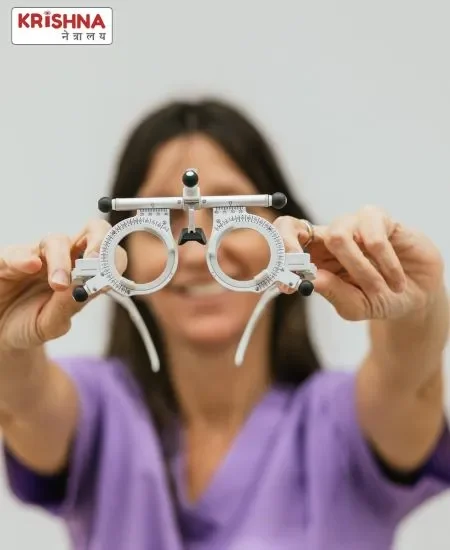 An women holding prescription glasses for refractive error treatment.